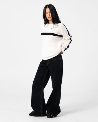 Woman wearing Wendy Wide Low Rise Denim Jean in Black Out