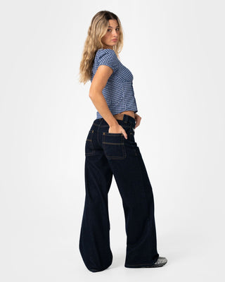 Woman wearing Wendy Wide Low Rise Denim Jean in Raw Dawg