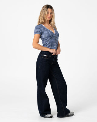 Woman wearing Wendy Wide Low Rise Denim Jean in Raw Dawg