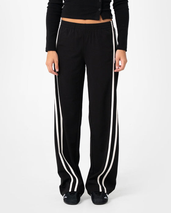 woman-wearing-bronson-low-rise-trackpant-in-black