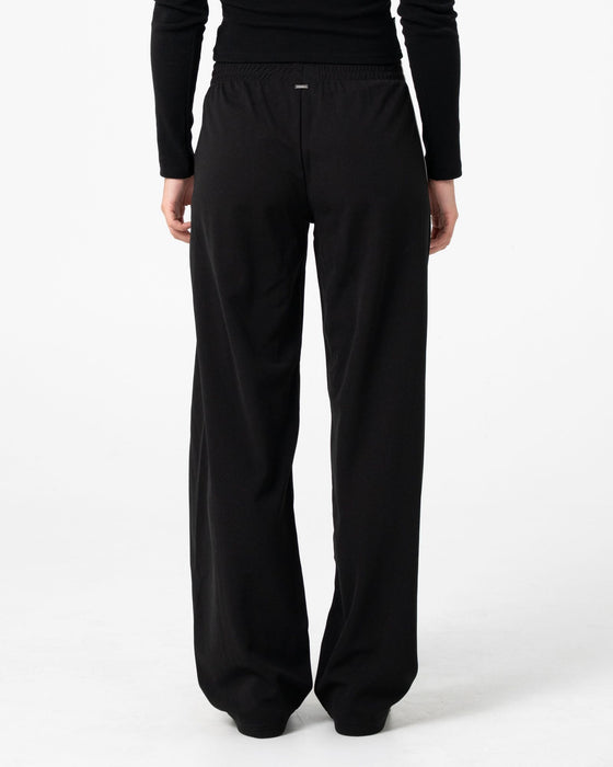 woman-wearing-bronson-low-rise-trackpant-in-black