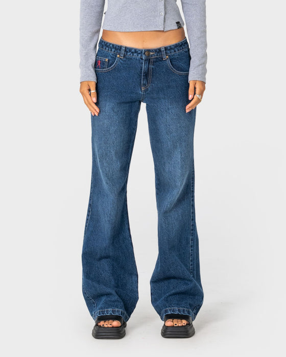 woman-wearing-shorty-freida-flare-low-rise-jeans-in-blasted-deep-sea-blue