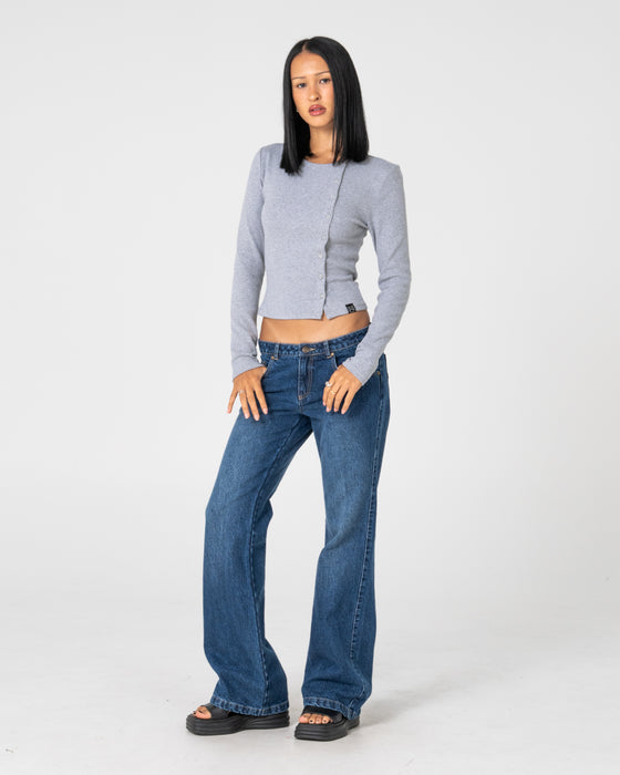 woman-wearing-shorty-freida-flare-low-rise-jeans-in-blasted-deep-sea-blue