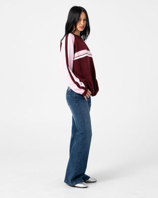 Woman wearing Shorty Freida Flare Low Rise Jeans in Blasted Deep Sea Blue