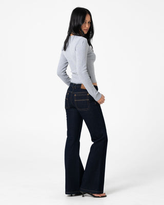 Woman wearing Freida Flare Low Rise Jeans in Raw Dawg Blue