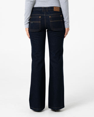 Woman wearing Freida Flare Low Rise Jeans in Raw Dawg Blue