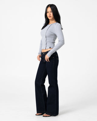Woman wearing Freida Flare Low Rise Jeans in Raw Dawg Blue