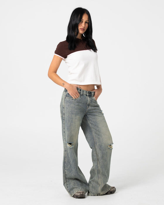 woman-wearing-insert-dad-joke-baby-polo-tee-in-cream-choc