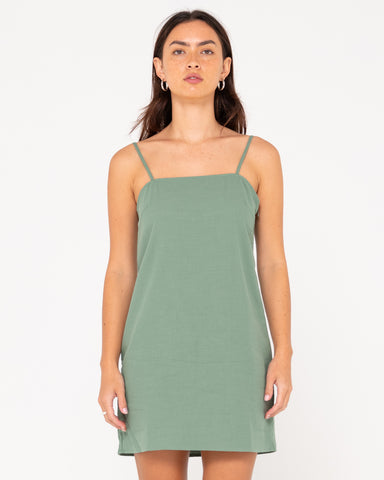 Woman wearing Sweet Water Mini Dress in Sage Leaf