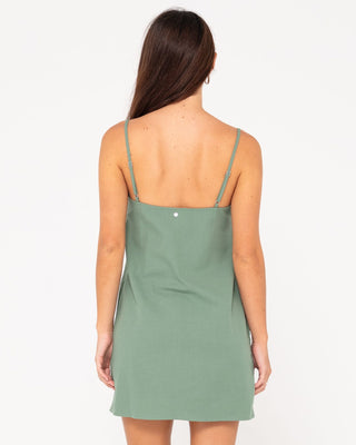 Woman wearing Sweet Water Mini Dress in Sage Leaf