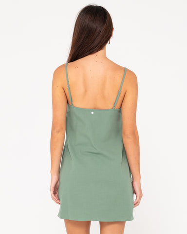 Woman wearing Sweet Water Mini Dress in Sage Leaf