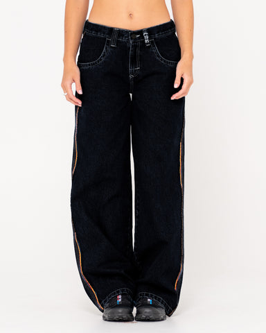 Woman wearing Flip Mommy Low Rise Wide Leg Denim Jean in Black Out/ Red Gold