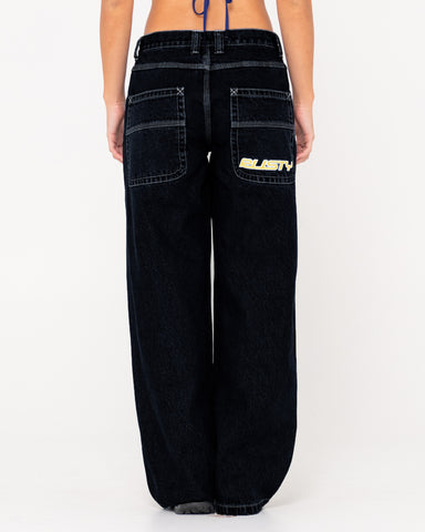 Woman wearing Flip Mommy Low Rise Wide Leg Denim Jean in Black Out/ Red Gold