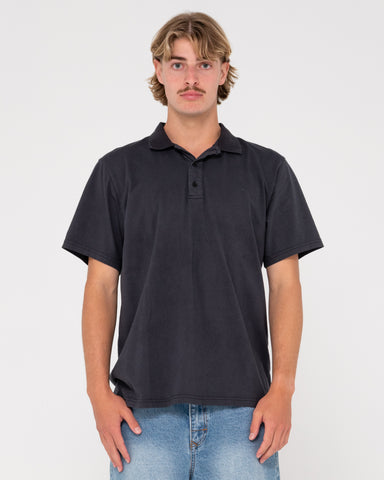 Man wearing Comp Wash Short Sleeve Polo in Black