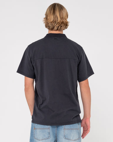 Man wearing Comp Wash Short Sleeve Polo in Black