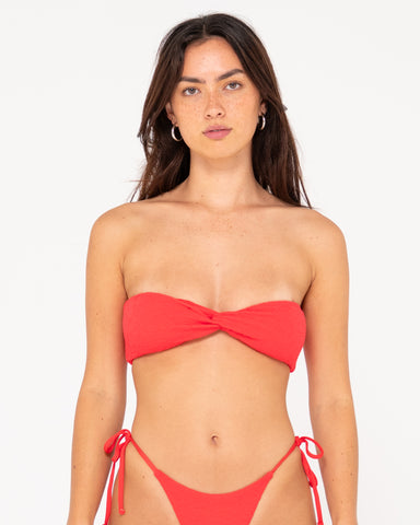 Woman wearing Sandalwood Twist Bandeau Bikini Top in Fiesta Red