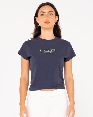 Woman wearing Rusty Essentials Skimmer Baby Tee in Navy Blue