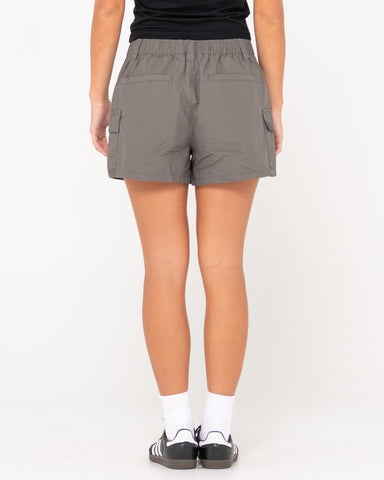 Woman wearing Milly Mid Rise Cargo Short in Coal