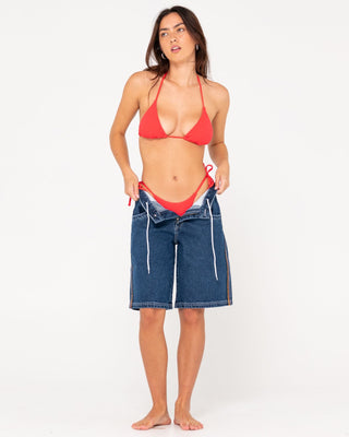 Woman wearing Flip Mommy Low Rise Wide Leg Denim Short in Deep Sea Blue / Red Gold