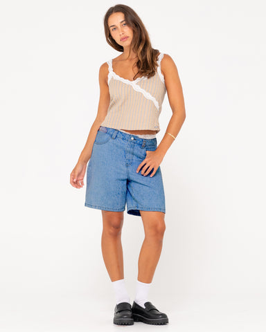 Woman wearing High Volume 18 Inch Denim Jort in Sea Blue