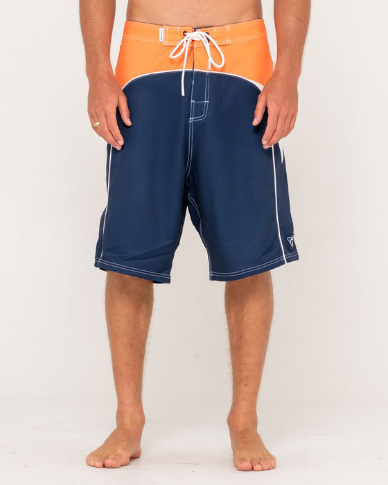 man-wearing-straight-pipe-fixed-waist-boardshort-in-navy-blue