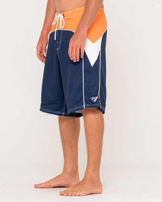 man-wearing-straight-pipe-fixed-waist-boardshort-in-navy-blue