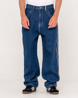 Man wearing Flip Daddy 2.0 Jean - Deep Sea Blue in Deep Sea Blue / Orange