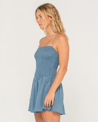 Woman wearing Mimi Smocked Mini Dress in Retro Blue