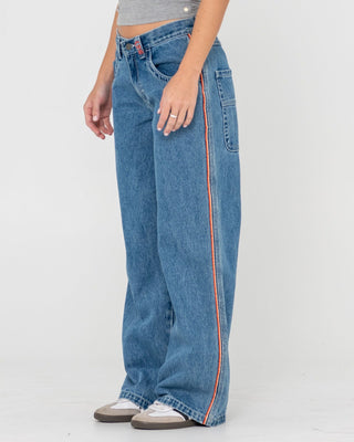 Woman wearing Flip Mommy Low Rise Wide Leg Denim Jean in Middy Blue / Orange