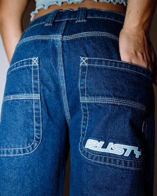 Woman wearing Flip Mommy Low Rise Tapeless Denim Jean in Deep Sea Blue