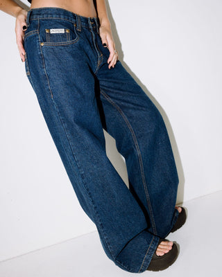 Woman wearing Wendy Wide Low Rise Denim Jean in Deep Sea Blue