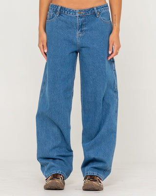 Woman wearing Risque Bethany Baggy Low Rise Denim Jean in Middy Blue