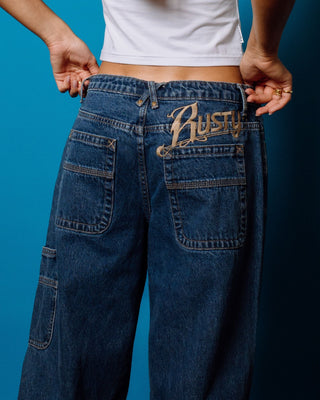Woman wearing Risque Bethany Baggy Low Rise Denim Jean in Middy Blue