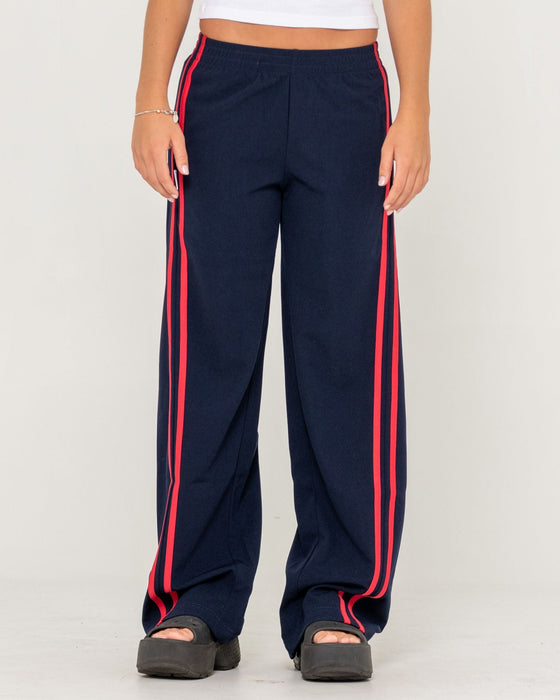 woman-wearing-bronson-low-rise-trackpant-in-navy-blue