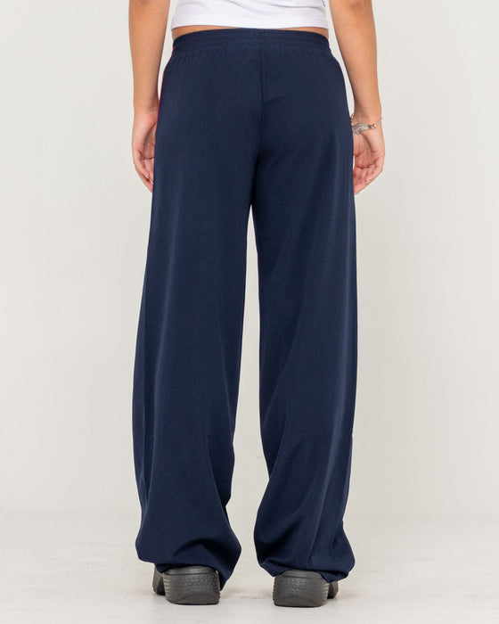woman-wearing-bronson-low-rise-trackpant-in-navy-blue