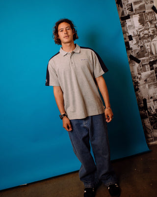 Man wearing Straight Shooter Short Sleeve Polo in Grey Marle