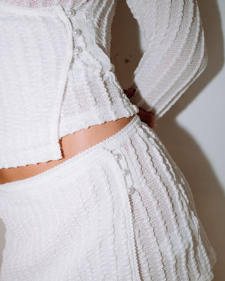 Woman wearing I Kissed A Pearl Lace Wrap Mini Skirt in White