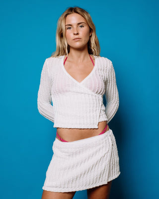 Woman wearing I Kissed A Pearl Lace Wrap L/S Top in White