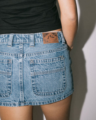 Woman wearing Mavericks Low Rise Denim Mini Skirt in Middy Blue