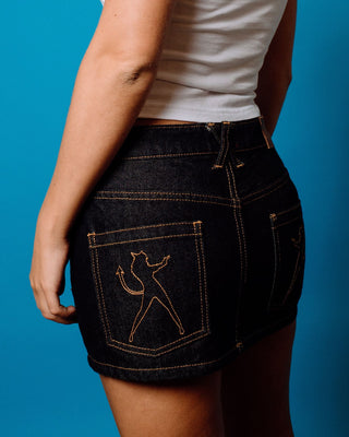Woman wearing Ripper Raw Low Rise Denim Micro Skirt in Raw Dawg Blue 1