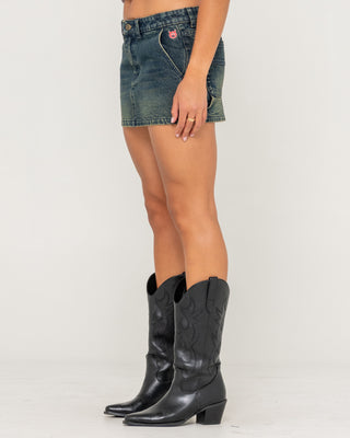 Woman wearing Billie Low Rise Denim Mini Skirt in Dark N Dirty