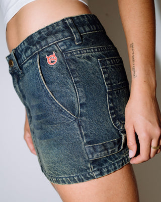 Woman wearing Billie Low Rise Denim Mini Skirt in Dark N Dirty