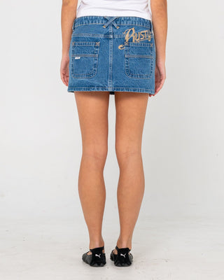 Woman wearing Risque Low Rise Denim Micro Skirt in Middy Blue