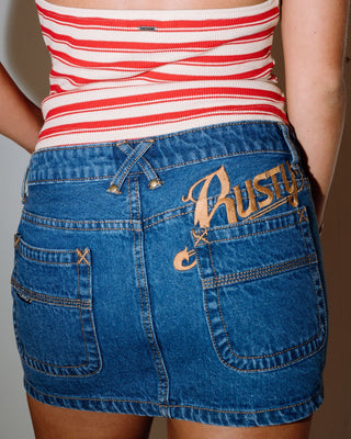 Woman wearing Risque Low Rise Denim Micro Skirt in Middy Blue