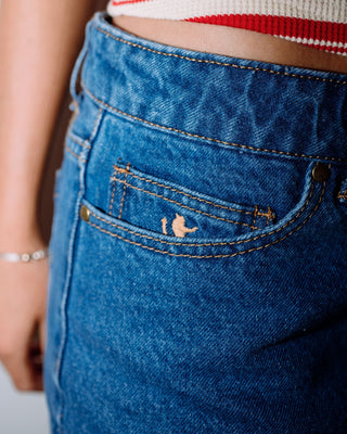 Woman wearing Risque Low Rise Denim Micro Skirt in Middy Blue