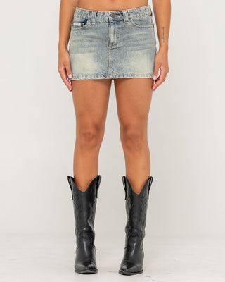 Woman wearing Dirty Mavericks Denim Mini Skirt in Dirty Dawg