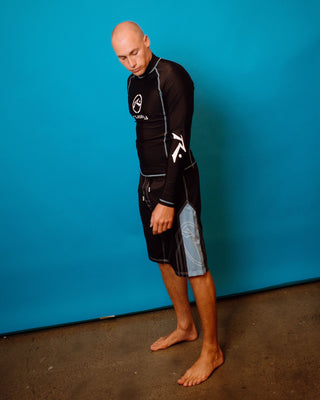 Man wearing Gnaraloo Long Sleeve Surf Top in Black