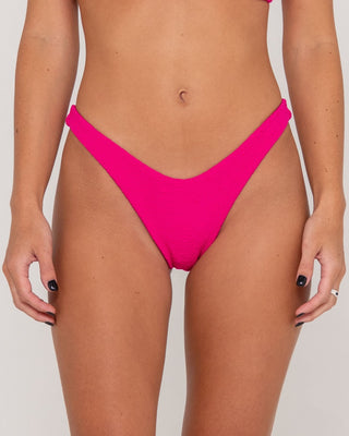 Woman wearing Sandalwood Brazilian Bikini Bottom in Fuchsia