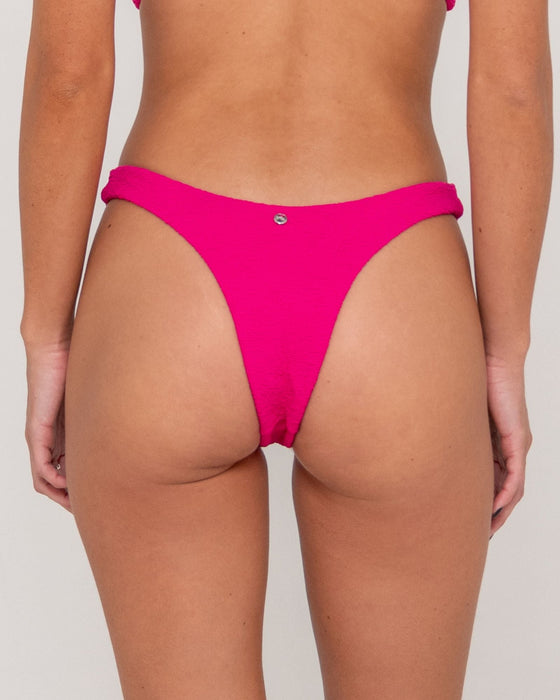 woman-wearing-sandalwood-brazilian-bikini-bottom-in-fuchsia
