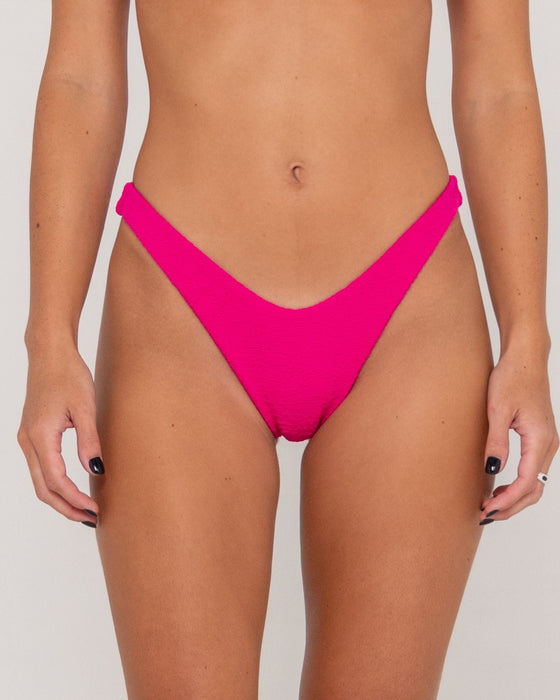 woman-wearing-sandalwood-midi-bikini-bottom-in-fuchsia